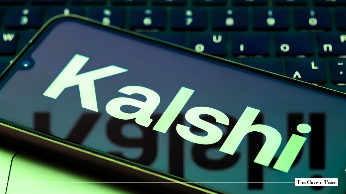 A smartphone displaying the light green Kalshi logo angled across a laptop keyboard.