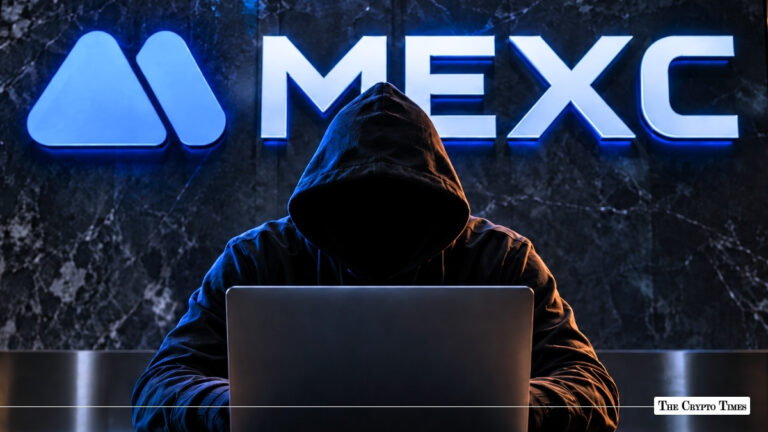 A hooded figure working on a laptop in front of an illuminated MEXC logo on a dark wall.