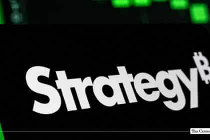 MicroStrategy logo with the Bitcoin "B" integrated into the final letter, set against a dark screen with green trading charts in the background