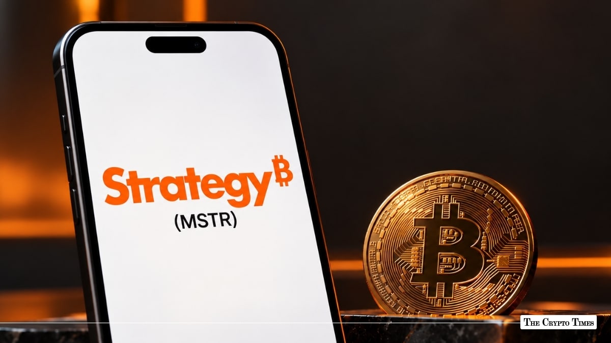 A smartphone displaying Strategy (MSTR) branding next to a gold Bitcoin coin.