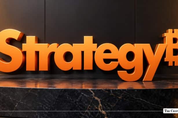 3D orange text spelling "Strategy" ending with an integrated Bitcoin symbol, set against a dark wall and marble surface.