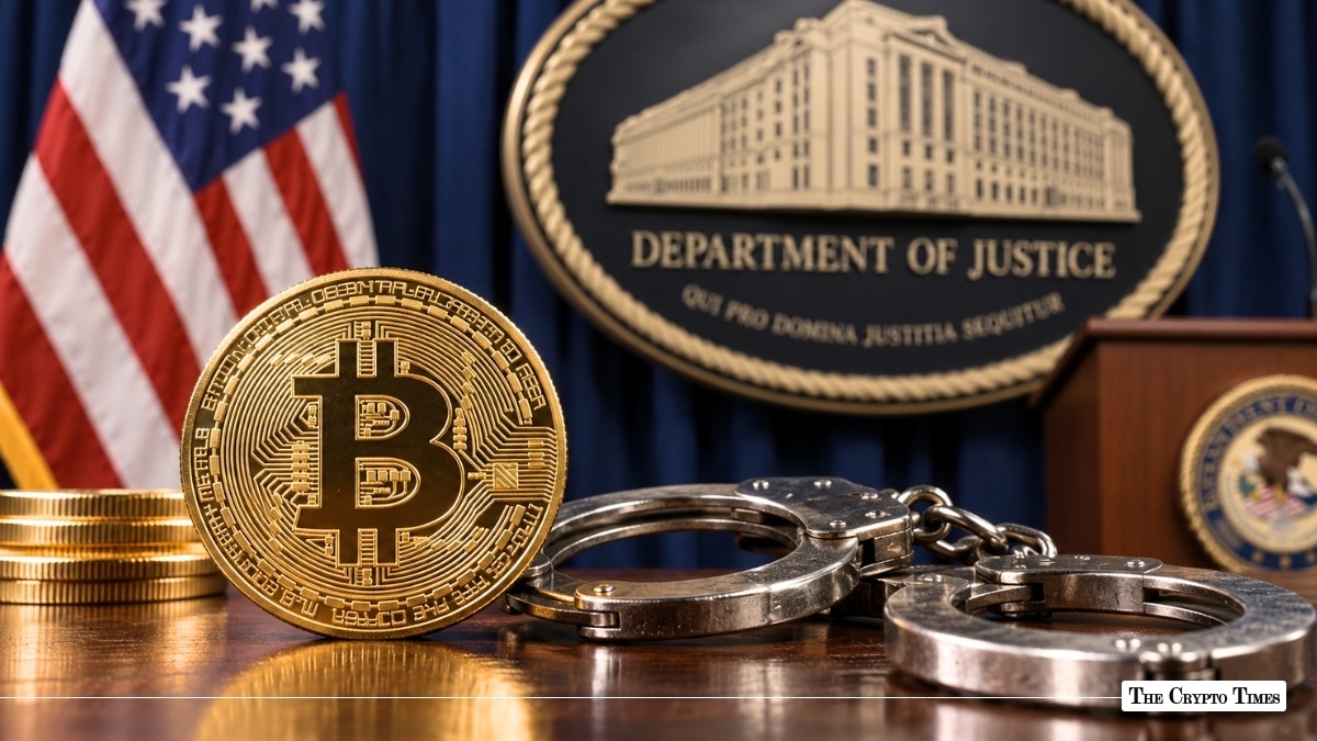 Gold Bitcoin coin and steel handcuffs resting on a wooden desk in front of the U.S. Department of Justice seal and American flag