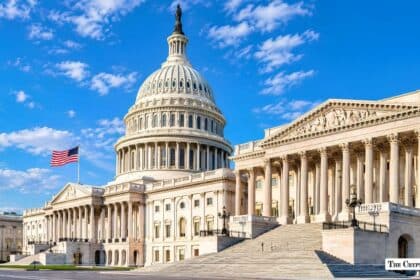 Exterior view of the United States Capitol building under a blue sky.