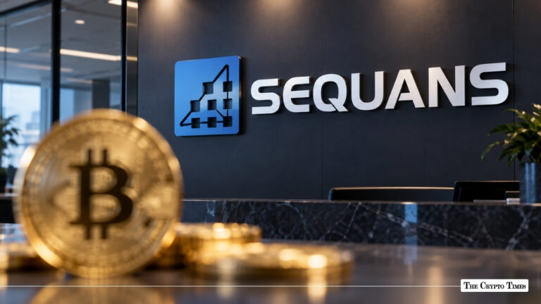 A physical gold Bitcoin coin in the foreground with the Sequans logo mounted on an office wall behind it.