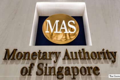 Gold-lettered building sign for the Monetary Authority of Singapore featuring the round MAS logo