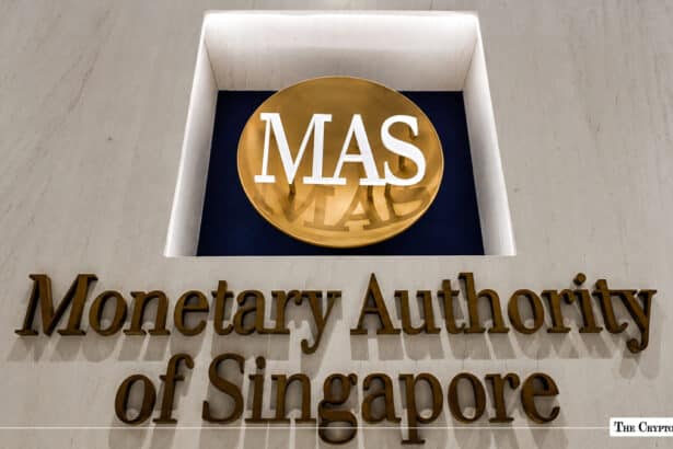 Gold-lettered building sign for the Monetary Authority of Singapore featuring the round MAS logo