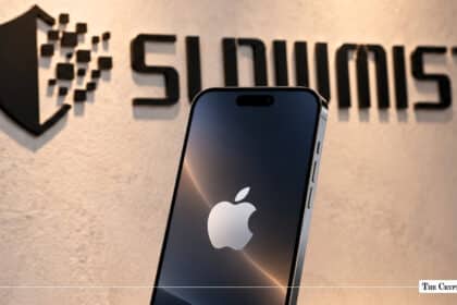 A smartphone displaying the Apple logo positioned in front of an illuminated SlowMist wall logo. JPG