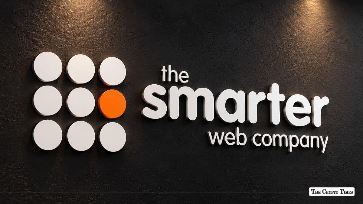 The Smarter Web Company logo mounted on a black wall.