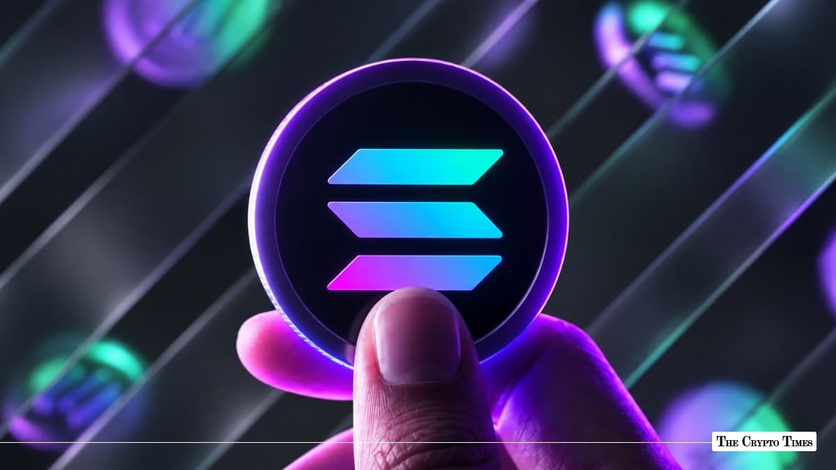 Hand holding a glowing purple 3D token displaying the cyan-and-pink Solana logo against a dark background with diagonal light tracks