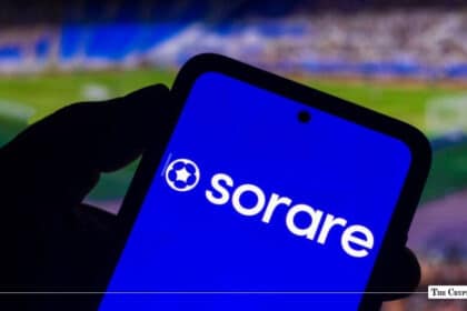 Smartphone displaying the Sorare logo on screen against a blurred football stadium background