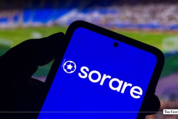 Smartphone displaying the Sorare logo on screen against a blurred football stadium background