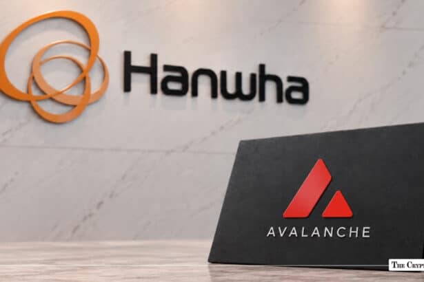 Hanwha logo mounted on a white marble wall with an Avalanche tabletop sign positioned in the foreground