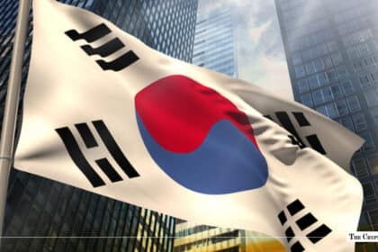 South Korean flag waving against a backdrop of modern glass financial skyscrapers