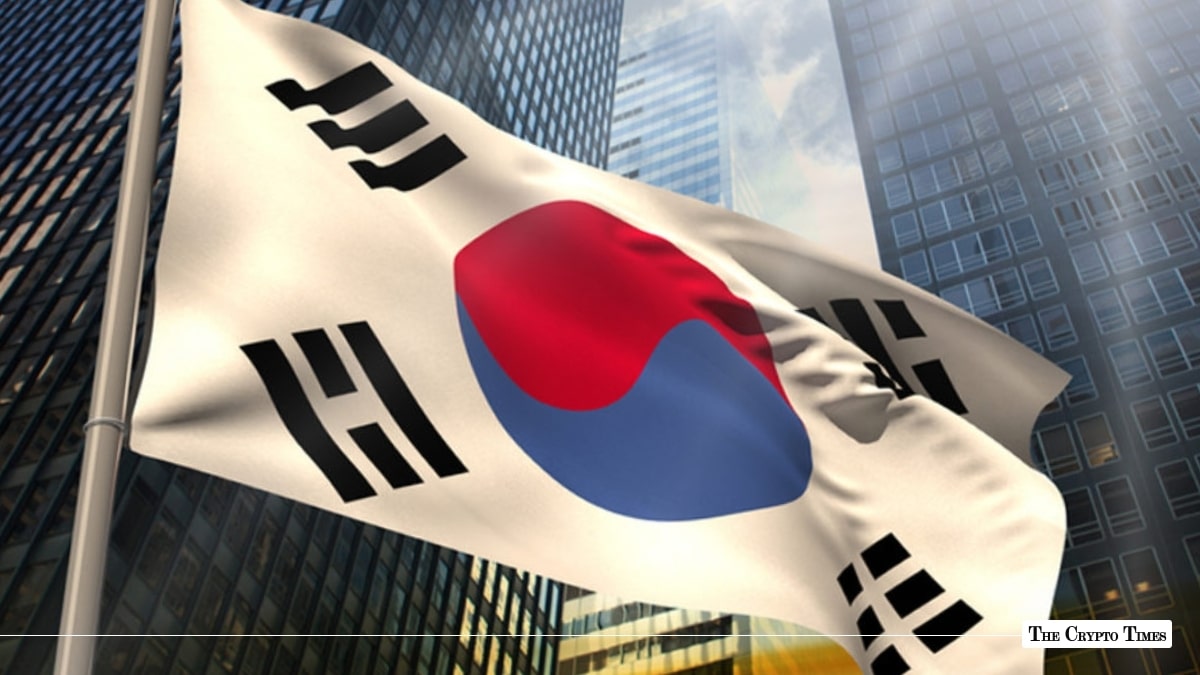 South Korean flag waving against a backdrop of modern glass financial skyscrapers