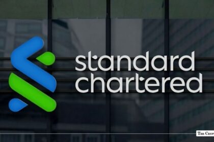 Standard Chartered logo displayed on the glass window facade of an office building