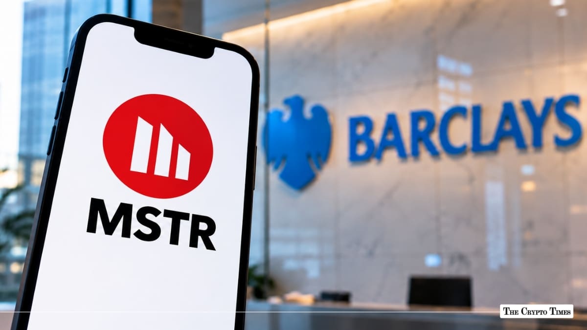 Smartphone displaying the MicroStrategy (MSTR) red circular logo with a blurred Barclays bank logo in the background