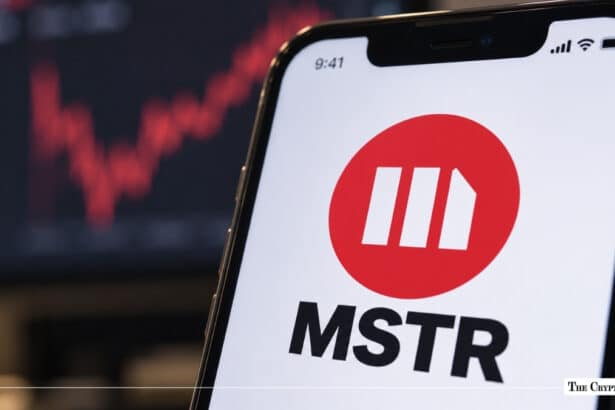 Smartphone displaying MicroStrategy MSTR stock ticker logo with stock chart in background