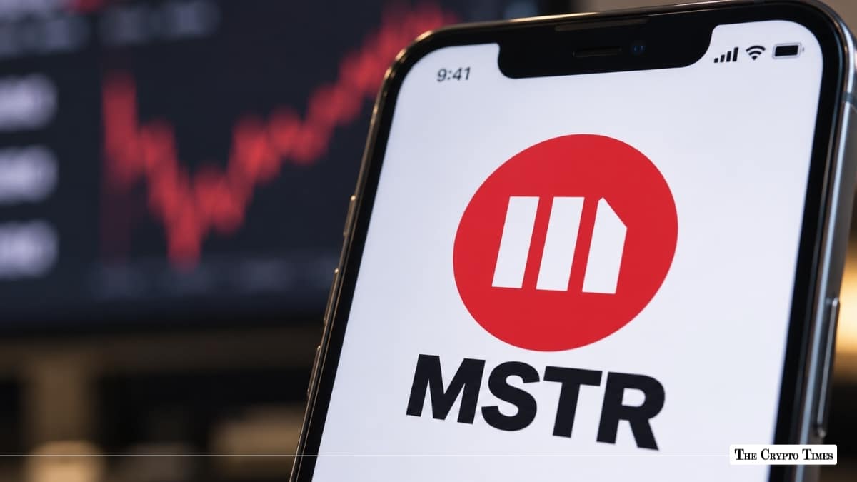 Smartphone displaying MicroStrategy MSTR stock ticker logo with stock chart in background