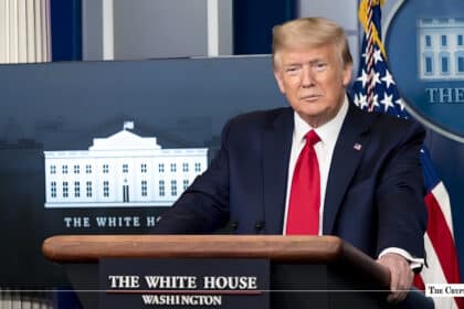 Donald Trump speaking at a podium in the White House press briefing room