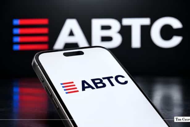 Handheld smartphone displaying the ABTC logo in front of a larger ABTC display banner.