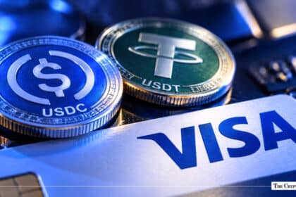 USDC and Tether USDT stablecoin coins resting on top of a Visa credit card