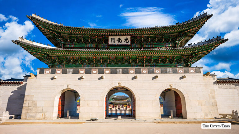 Gwanghwamun Gate in Seoul, South Korea, under a bright blue sky.