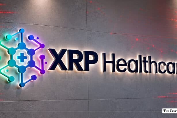 Illuminated 3D XRP Healthcare logo mounted on a concrete wall alongside a red digital network graphic overlay