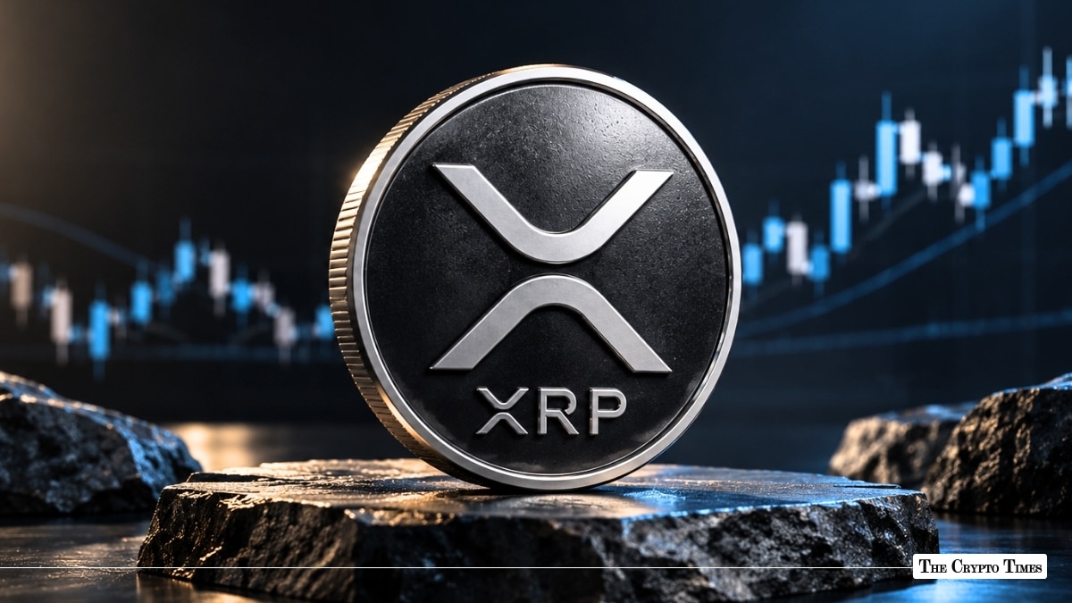 Silver physical XRP coin displayed on a stone pedestal against a blue market chart.