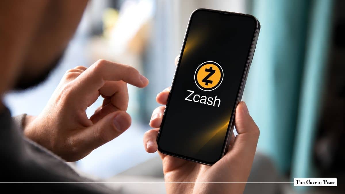 Person holding a smartphone displaying the Zcash logo and text.