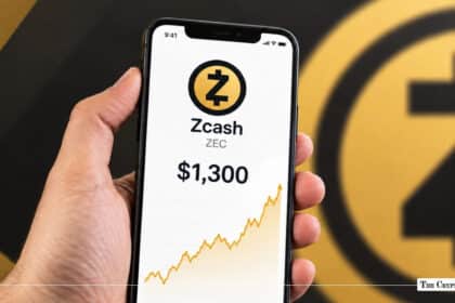 A hand holding a smartphone showing Zcash (ZEC) priced at $1,300 with an upward chart.