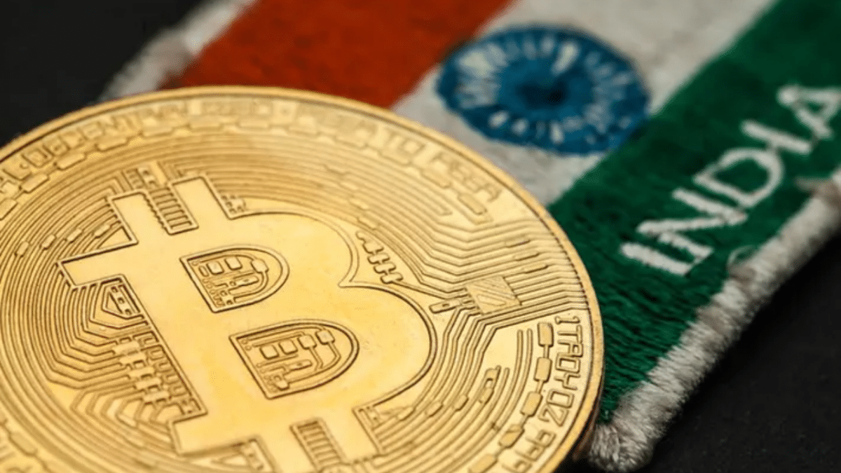 Bitcoin coin with the Indian rupee in the background.