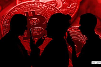 Dark red composition featuring silhouetted people holding smartphones against a backdrop of giant red physical Bitcoin coins