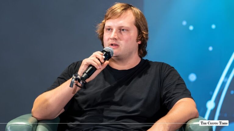 Aave founder and CEO Stani Kulechov speaking into a microphone during a conference panel.