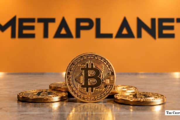 Physical Bitcoin token resting in front of the orange Metaplanet corporate wall logo