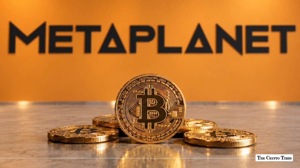 Physical Bitcoin token resting in front of the orange Metaplanet corporate wall logo