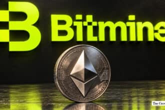Silver Ethereum ETH coin in front of the Bitmine corporate logo