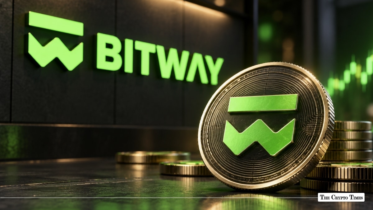 Physical Bitwave coin standing upright in front of a green illuminated Bitwave wall logo