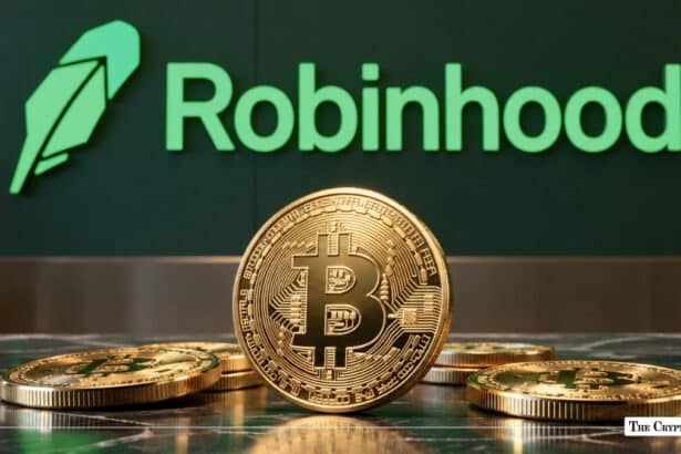 Physical Bitcoin (BTC) coin standing among scattered tokens in front of a green Robinhood office logo wall