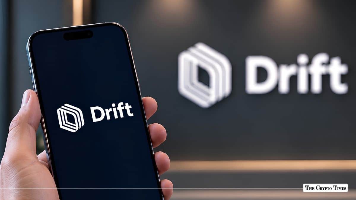 Hand holding a smartphone displaying the Drift Protocol logo, with a blurred 3D Drift wall sign in the background.