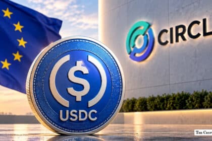 Physical USDC coin standing in front of Circle corporate building and the EU flag