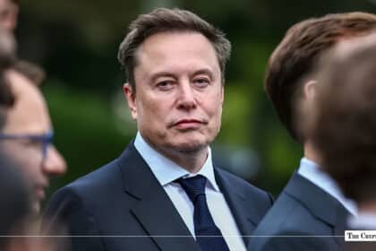 Tesla and SpaceX CEO Elon Musk wearing a dark suit and blue tie while attending an event
