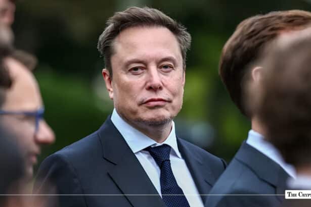 Tesla and SpaceX CEO Elon Musk wearing a dark suit and blue tie while attending an event