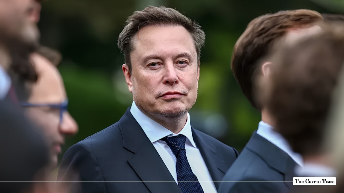 Tesla and SpaceX CEO Elon Musk wearing a dark suit and blue tie while attending an event