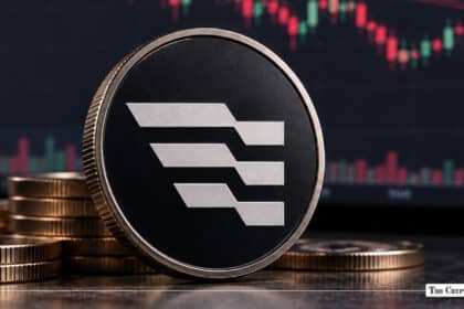 Aptos APT cryptocurrency coin in front of a financial market chart