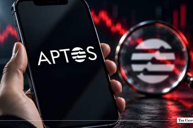 Smartphone screen displaying the Aptos APT logo next to a magnifying glass and red market trend chart