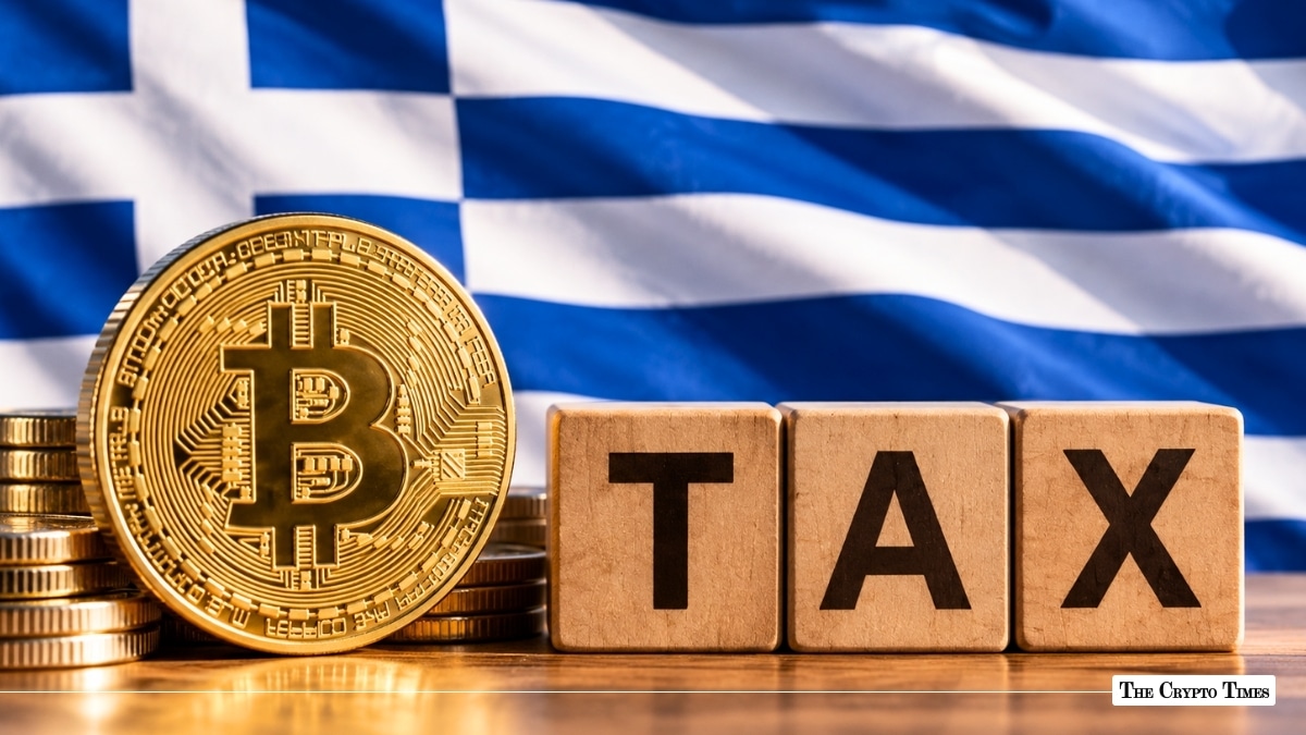 Physical gold Bitcoin coin standing beside wooden blocks spelling "TAX" in front of the flag of Greece