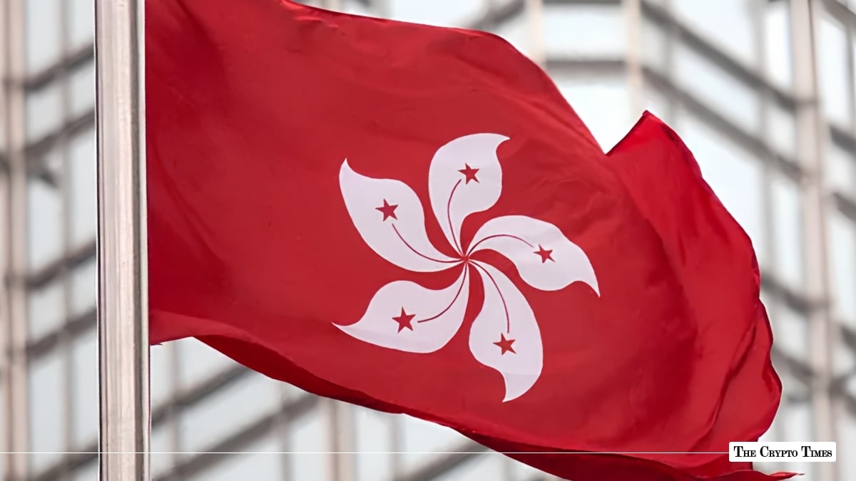 Hong Kong flag waving near financial district skyscraper representing crypto regulation hub