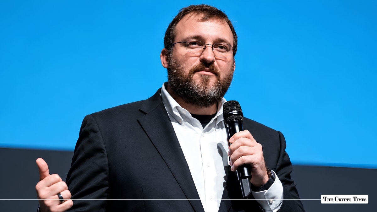 Charles Hoskinson speaking into a microphone on stage.