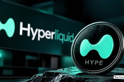 Physical Hyperliquid (HYPE) token coin standing upright with the green Hyperliquid logo and text displayed on a screen in the background