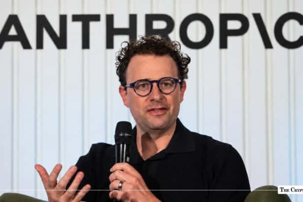 Anthropic CEO Dario Amodei speaking with the Anthropic logo background